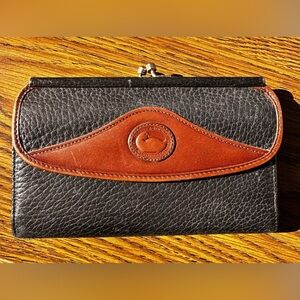 Vintage Dooney & Bourke black and tan kisslock trifold wallet.